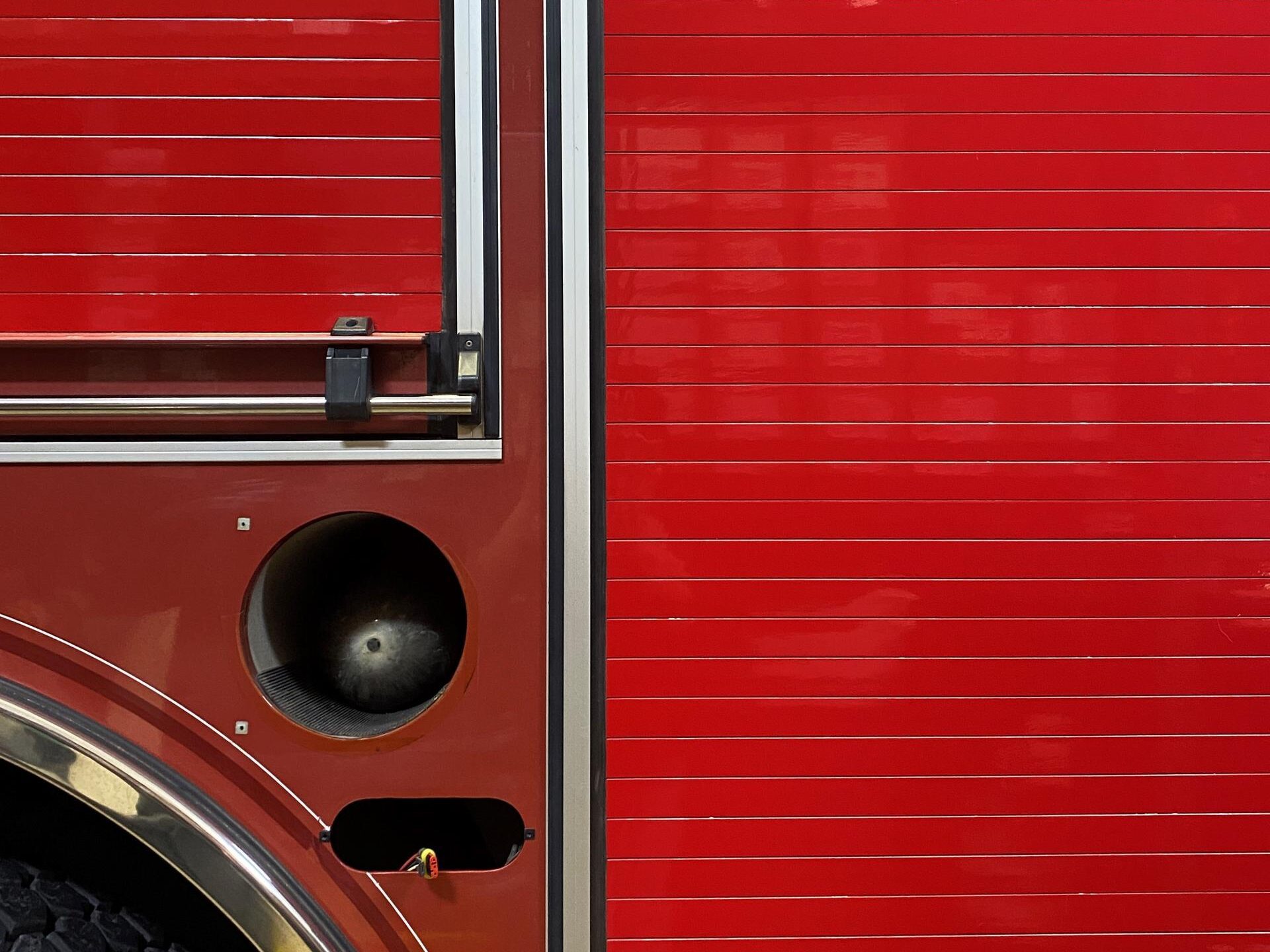 The bright cherry red vinyl on the roll up doors brings consistency to their fleet of rescue vehicles. 